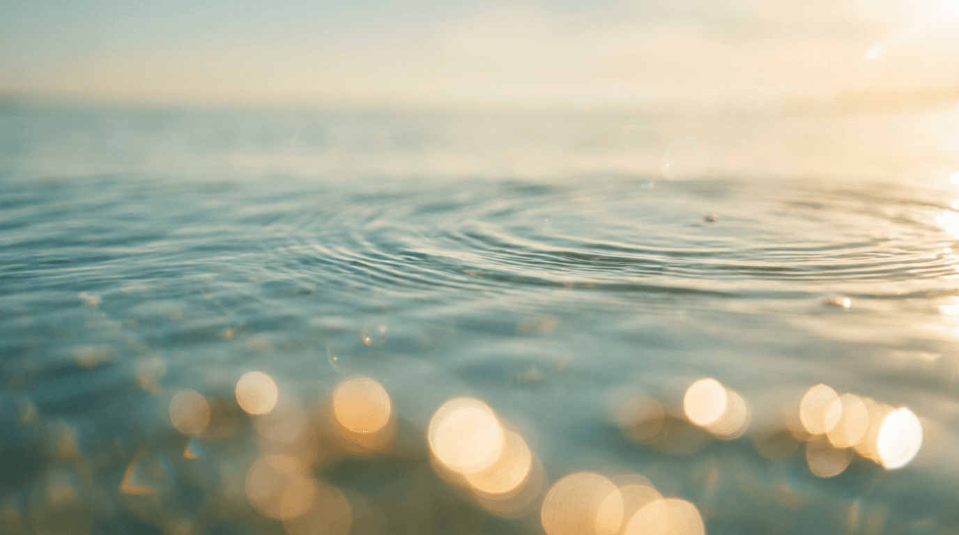 Sunlit water surface with ripples, bokeh reflections, and golden hour shimmer
